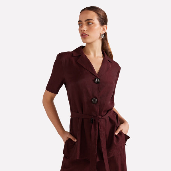 Our Astor Belted Shirt is available in a wine colour and features a collar, button front, short sleeves and a belt.
