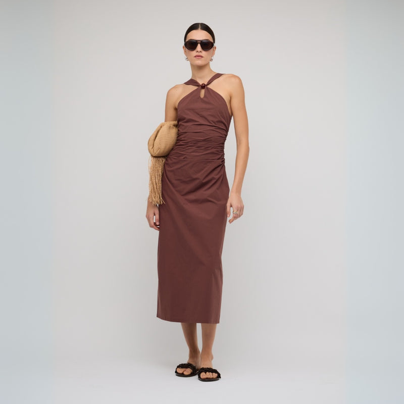 This dress features a cross-over detail on the neckline, fitted throughout the body with gathered detailing along the waist.