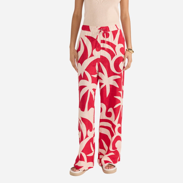 Our Rhodes Resort Pants have a bold red and beige print.