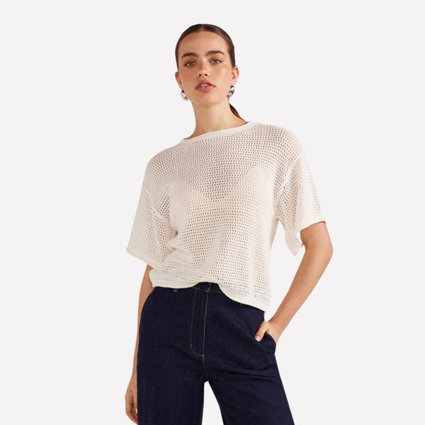 This white knit top has a round neckline, drop shoulder, short sleeves and a relaxed body