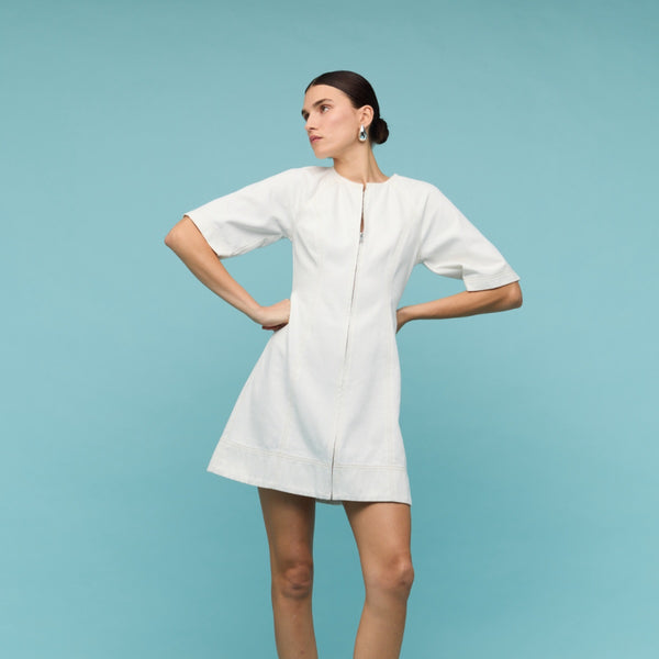 Our Zenith Denim Dress has a round neckline, zip front, short sleeves and an Aline skirt.