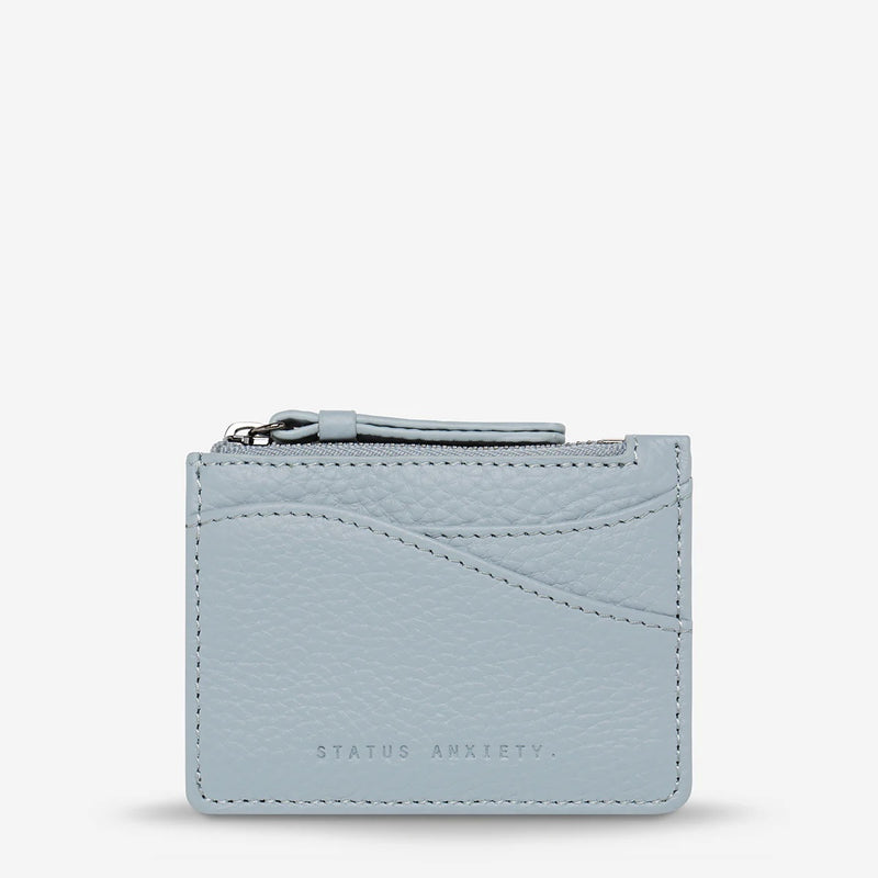 The front of the compact wallet has external compartments.