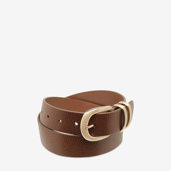Let It Be leather wallet by Status Anxiety in tan with a gold buckle.