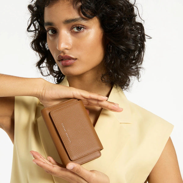 Model holding the leather wallet.