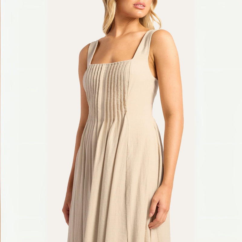 Close up of the square neckline, sleeveless style and the beautiful pleat detailing on the bodice.