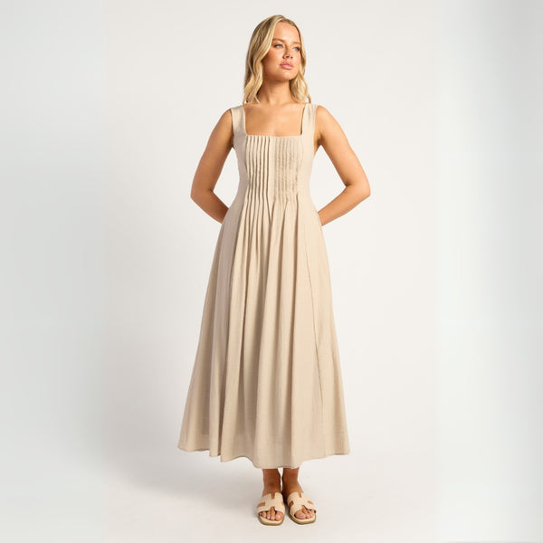 Our Reem Midi Dress is a classic style with a square neckline, shoulder straps and pleat detailing on the bodice.