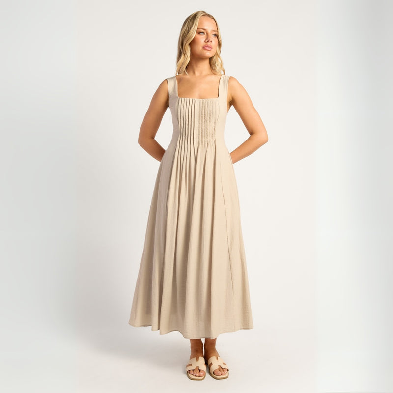 Our Reem Midi Dress is a classic style with a square neckline, shoulder straps and pleat detailing on the bodice.