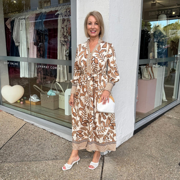 This dress can be accessorised with a white clutch and heels.