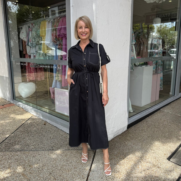 Our Bexley Shirt Dress is available in a dark navy colour and it has white top stitching.