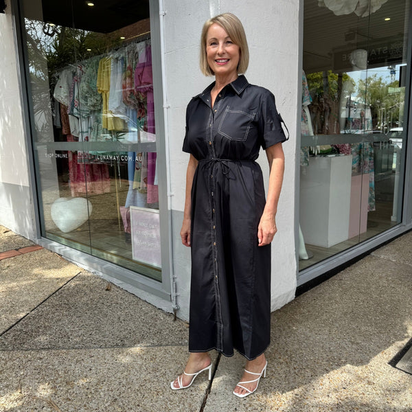 The dress has a collar, short sleeves, midi length skirt.