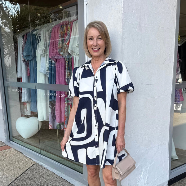 This shirt dress has a collar, short sleeves, button front and it finishes above the knee.