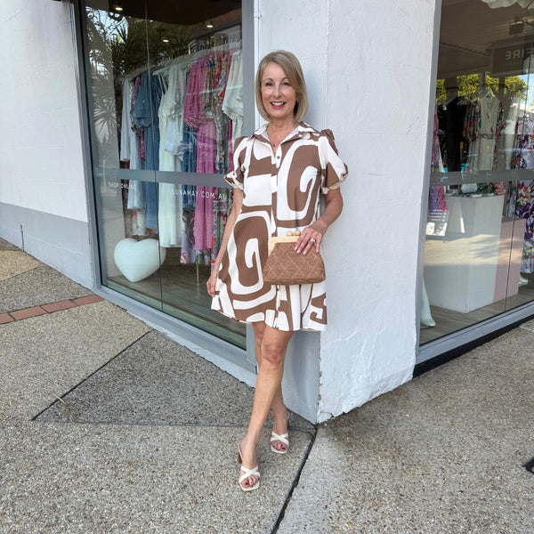 This short dress has a collar, button front, short sleeves and an Aline body.