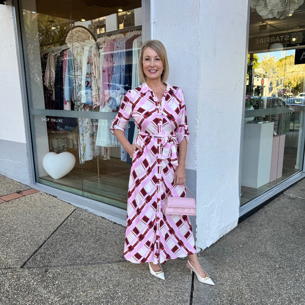 Our Mirren Shirt Dress has a beautiful checkered print in burgundy, pink and off-white tones.