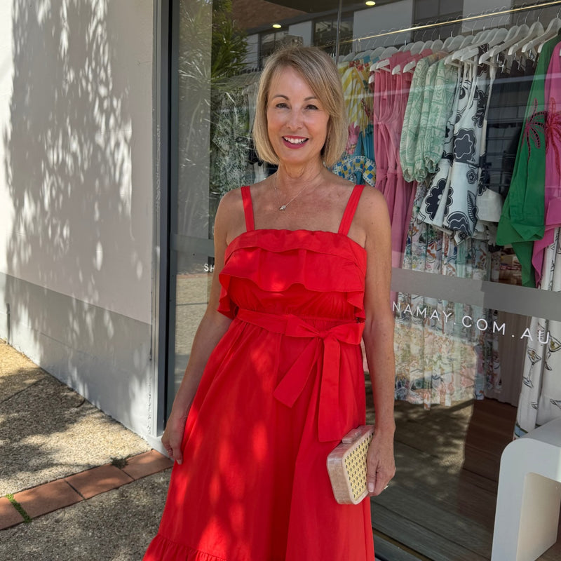 Close up of the bodice area - featuring adjustable shoulder straps, frill accents across the bodice and a detachable self fabric tie.