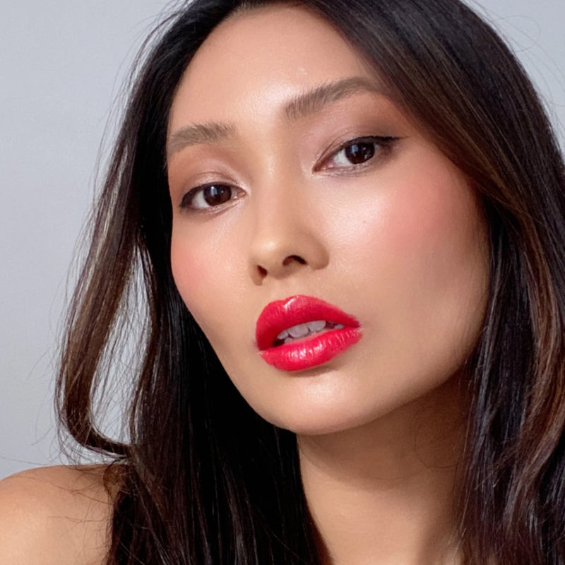 The Suzy x SJ Lipstick has a bold pop of a pink-red colour