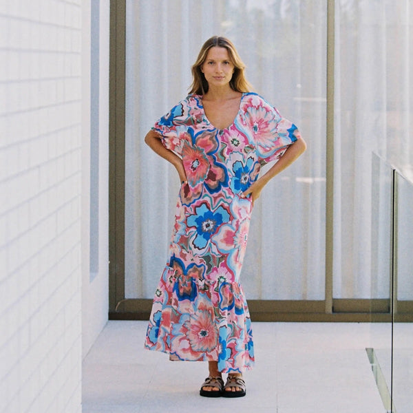 Full length view of the dress being worn without the belt which creates a loose flowing shape.