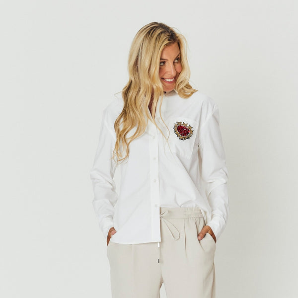 The shirt has a collar, long sleeves and it has a regular fit.