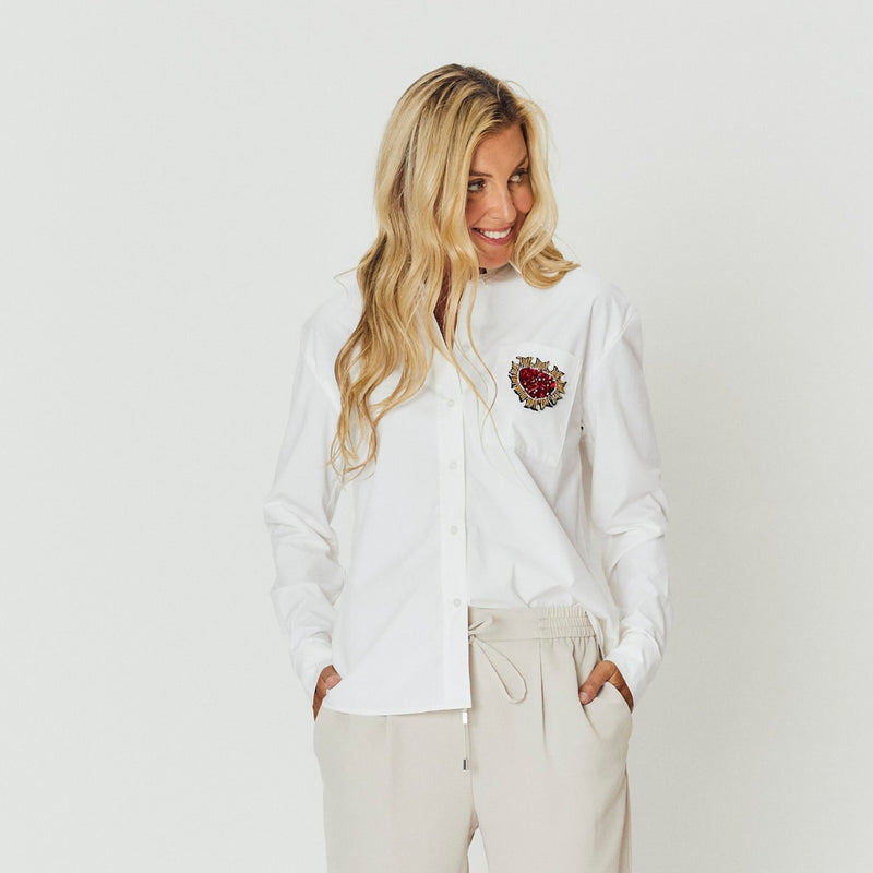 The shirt has a collar, long sleeves and it has a regular fit.