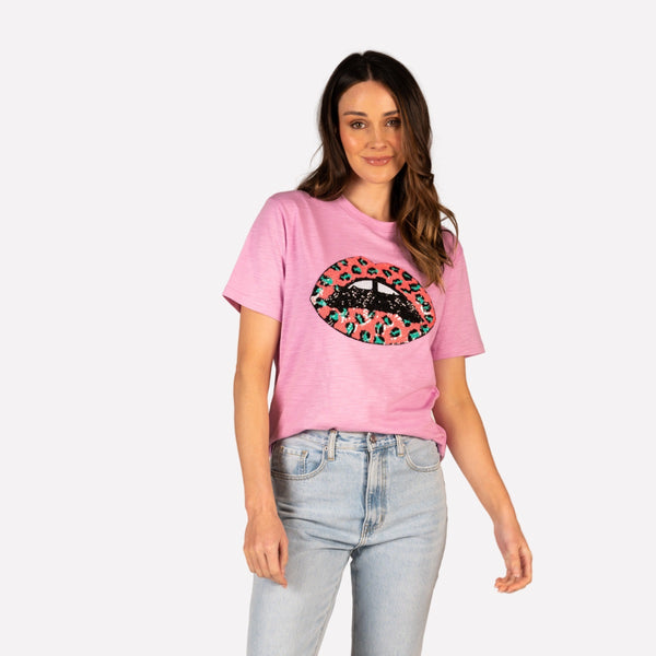 This pink tee has short sleeves and a round neckline