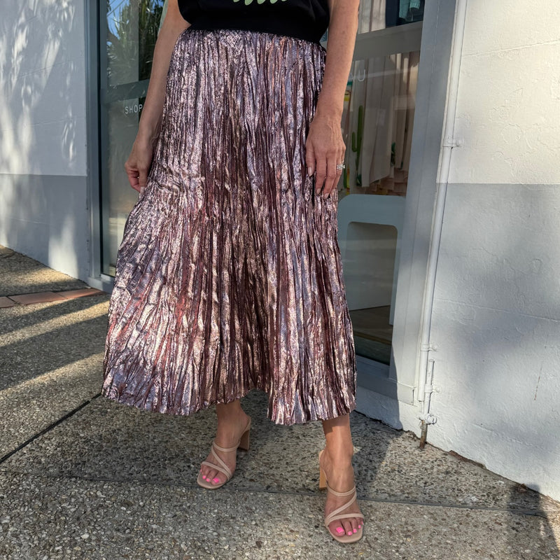 Our Lilian Pleat Skirt by We Are The Others is available in a pink shimmer fabric.