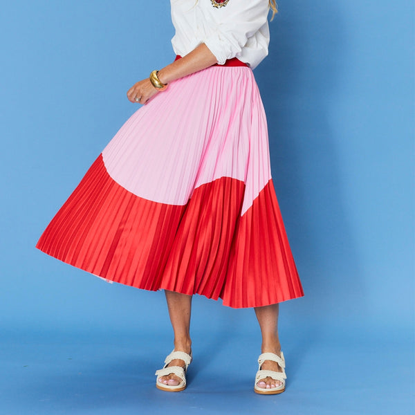 Our Lillian Pleated Skirt is in a red and pink wave print.
