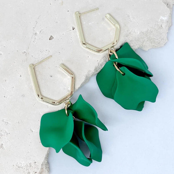 These earrings have green petals suspended from a gold hexagonal hoop with stud closure