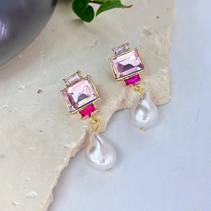 These beautiful earrings have pink jewels and a faux pearl drop with stud closure