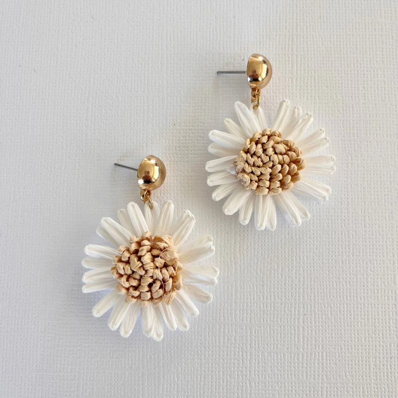 These white raffia flower shaped earrings are suspended from a gold metal stud back closure.