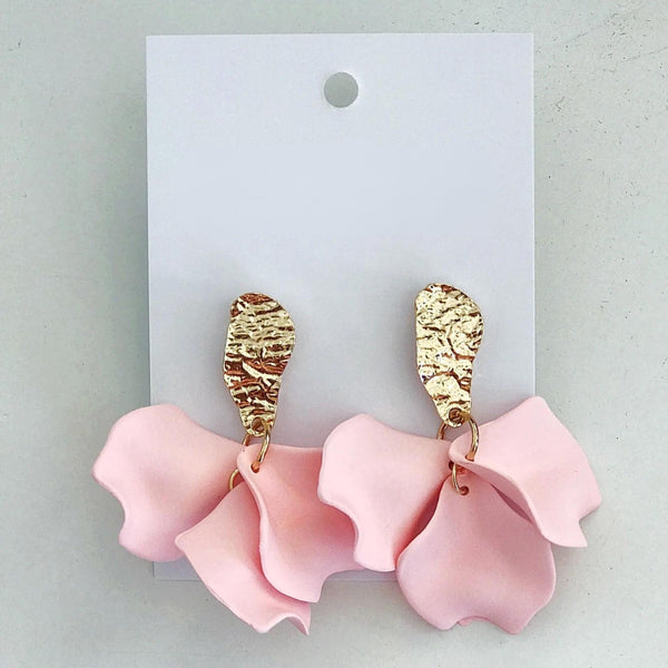 These earrings have pink petals suspended from a gold hammered stud