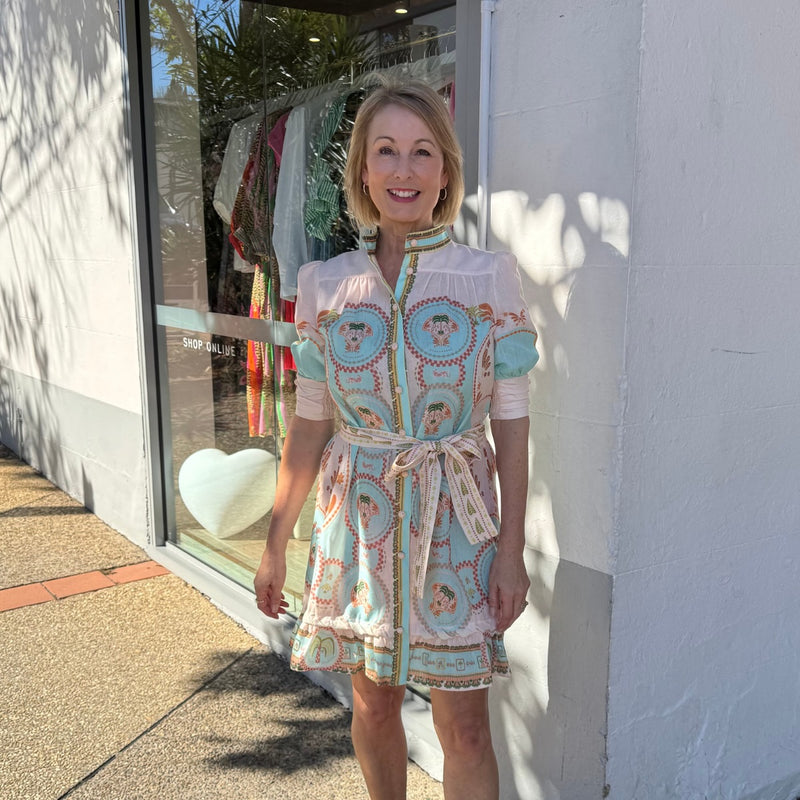 The dress features a button front, short sleeves, a self print waist tie and it finishes above the knee.