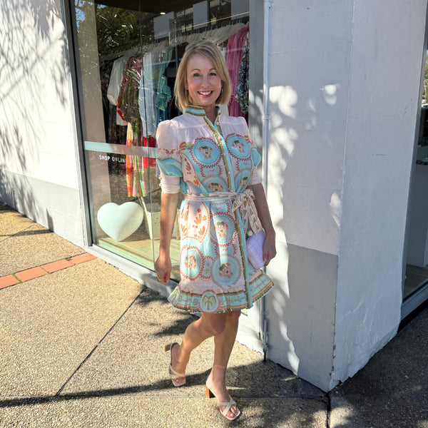 This dress has a mock collar that can be worn up and it also has a button front.