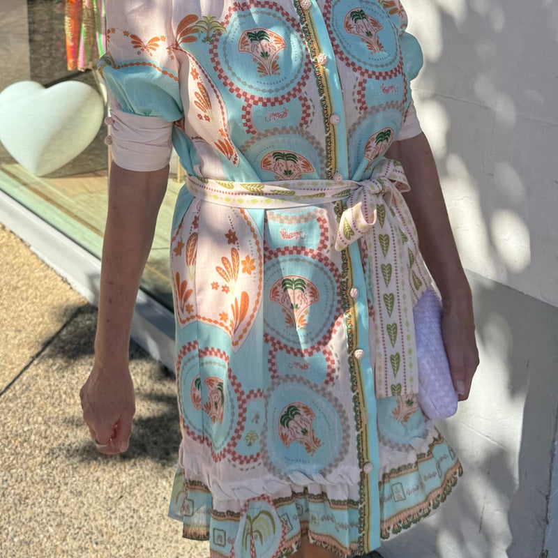 Close up of the sleeve detail - it has pleat detailing on the cuff and crochet buttons. There is also a self print waist tie.