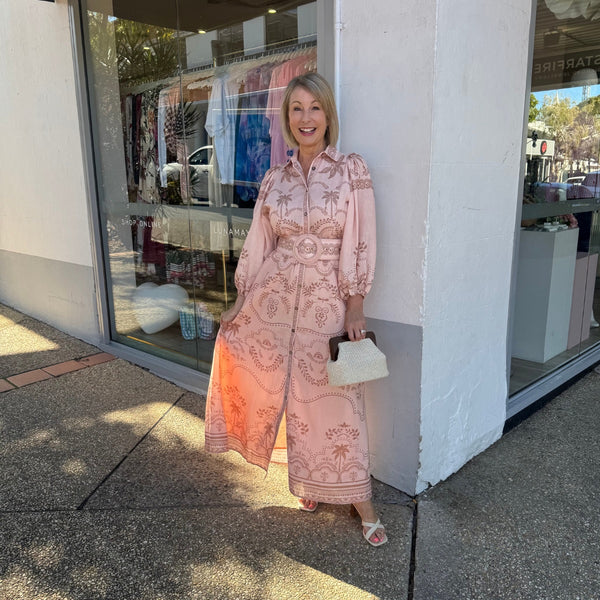 Our Xander Dress has a pretty palm and leaf print in peach and mocha tones.