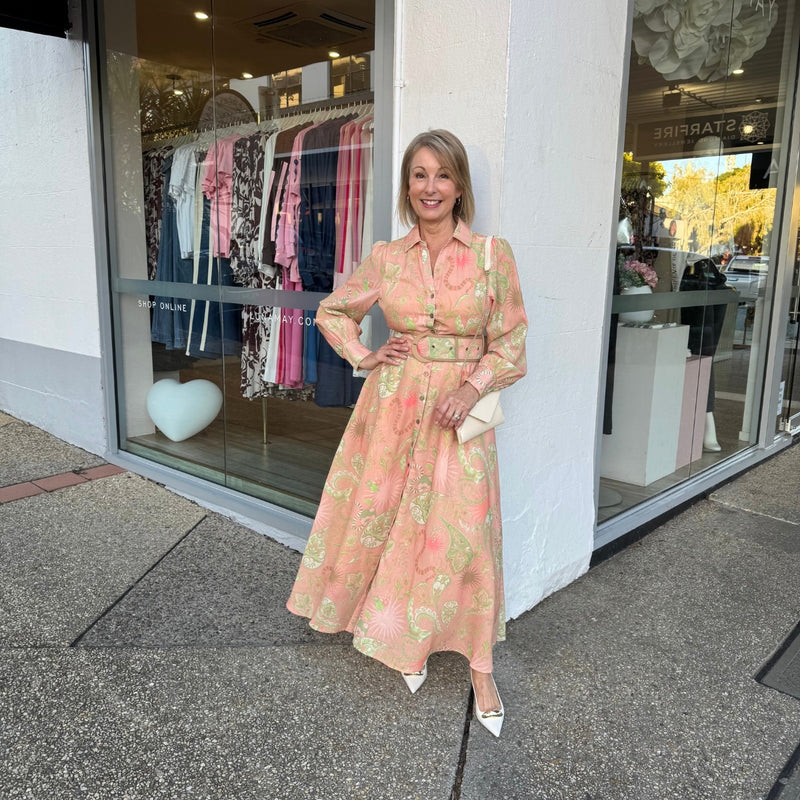 This shirt dress has a collar, long sleeves, button front, Aline maxi skirt and a statement belt.