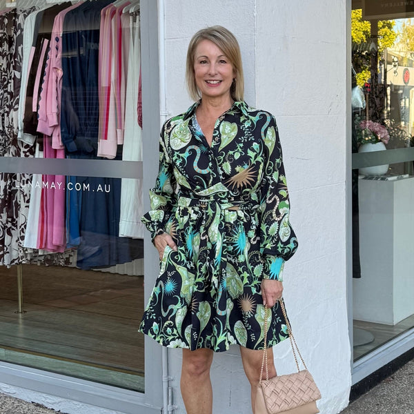 The dress features a collar, button bodice, long sleeves and it has fixed waist ties which create a lovely shape.