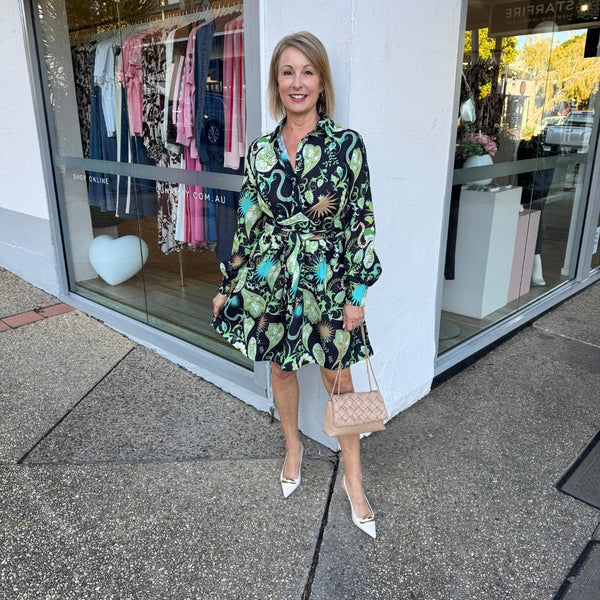 Our Zaria Dress has a statement 'midnight green' print featuring paisley, the sun and snakes to name a few. Colours include black, green, blue, brown and cream tones.