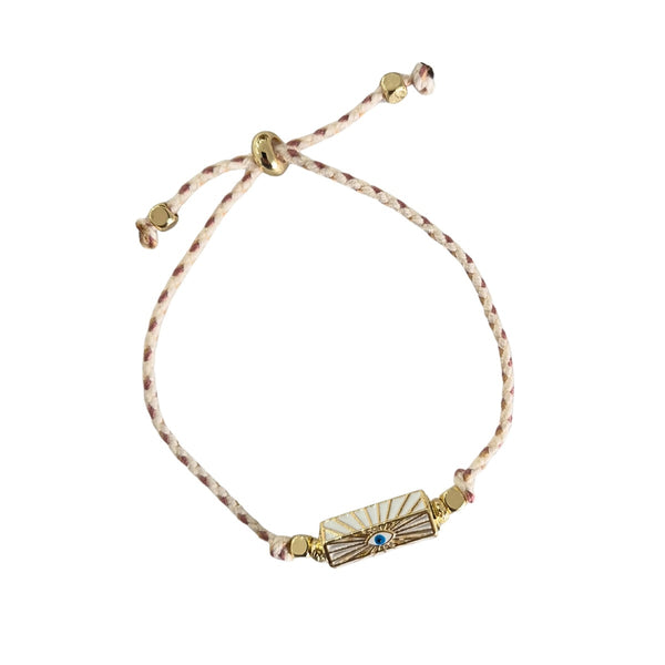 Zoda Cord Bracelet with a plaited cream and gold cord and a rectangle shaped 'Gold Eye' charm.