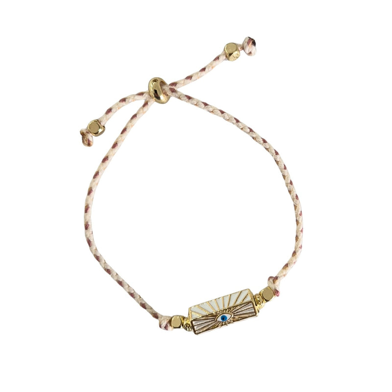 Zoda Cord Bracelet with a plaited cream and gold cord and a rectangle shaped 'Gold Eye' charm.