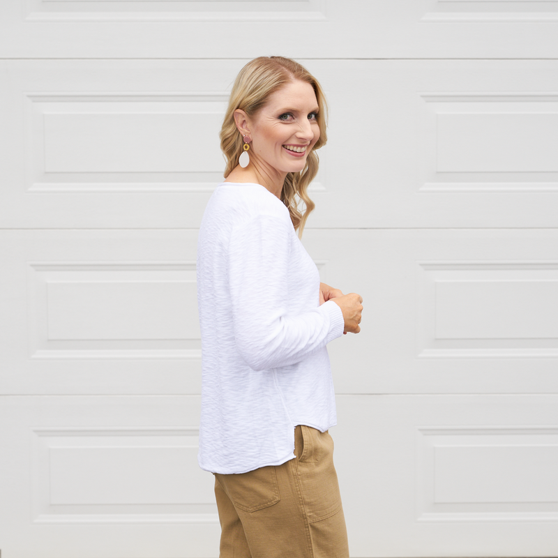 Sasha Knit Top has long sleeves and a curved, high low hemline